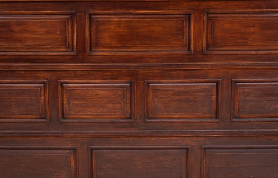 Close-up of a vintage wooden panel door showcasing rich textures and natural brown tones.